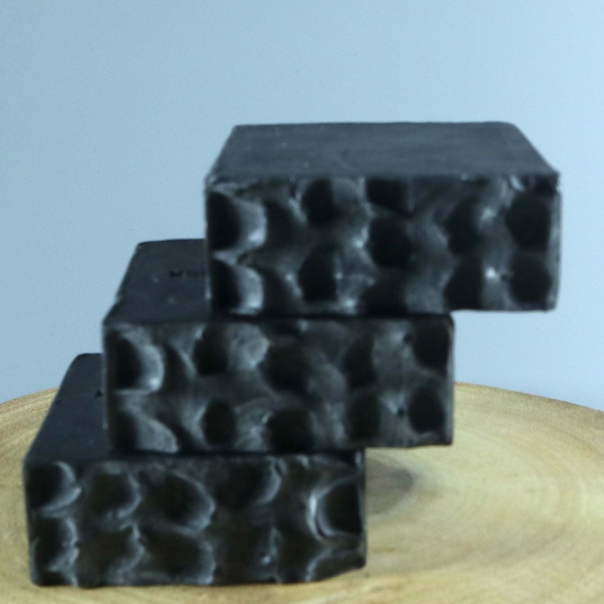 Black charcoal soap displaying the design
