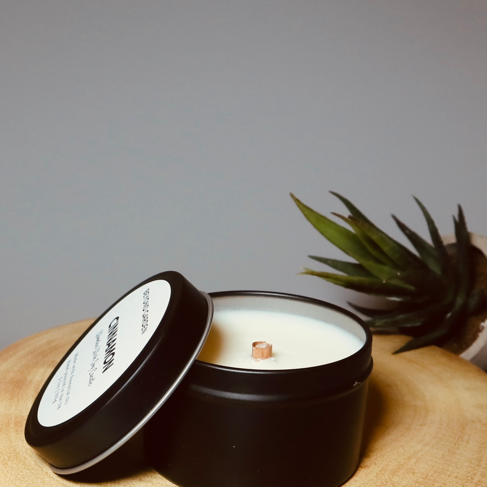 Cinnamon wooden wick candle in a lovely black travel tin
